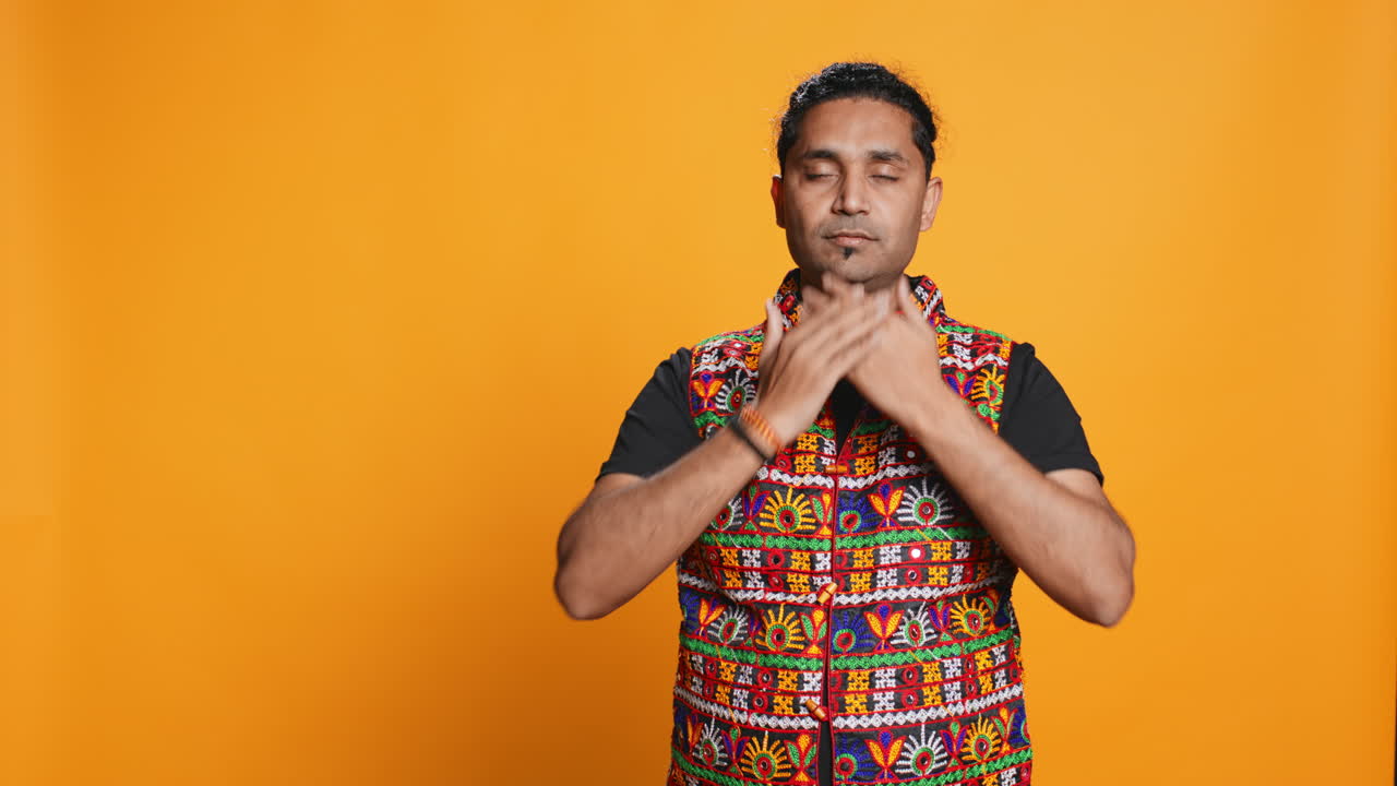 Man doing don`t see, don`t hear and don`t speak gesturing, studio background,