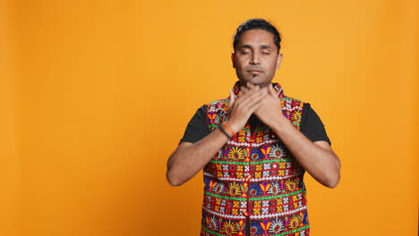man doing don`t see, don`t hear and don`t speak gesturing, studio background,