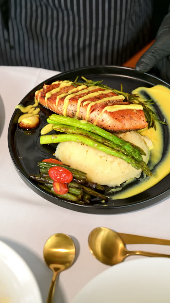 Steak and salad served on table. Grilled steak with rice, asparagus, beans and fresh salad on a white table