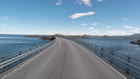 driving a car on a road in norway atlantic ocean road or the atlantic road (atlanterhavsveien) been awarded the title as (norwegian construction of the century).