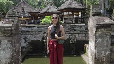 western tourist balinese temple ubud bali indonesia goa gajah posing in holiday