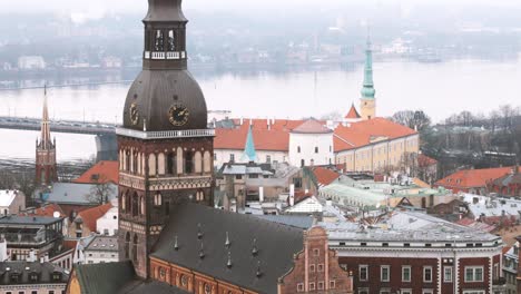 riga, latvia. top view of cityscape and famous landmark - riga dome cathedral in misty fog rainy day