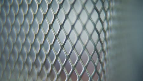 a hyper macro shot of a metal grid, steel pattern, iron industrial texture, aluminum material, super slow motion, full hd 120 fps, tilt up smooth movement