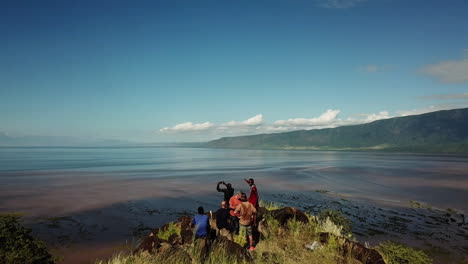 beautiful 4k drone shot of some hikers who have climbed to the top of a mountain in east africa, with the help of some african sherpas, showing a beautiful landscape of colors