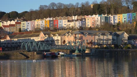 people cross footbridge on sunny day at bristol harbourside 4k