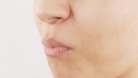 close-up portrait of woman eating carrot. eating vegetables.