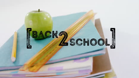 animation of back to school text over apple and school items