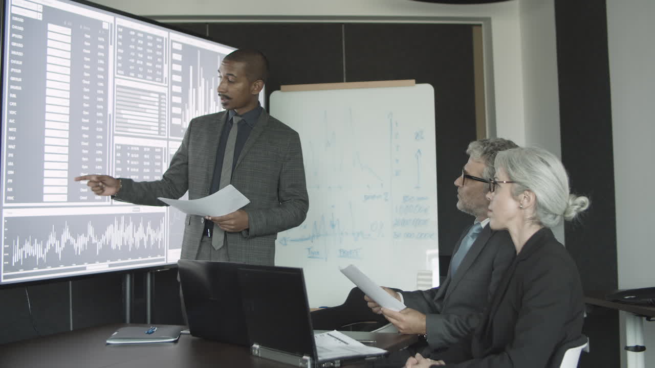 Professional investor presenting stock market statistics to clients