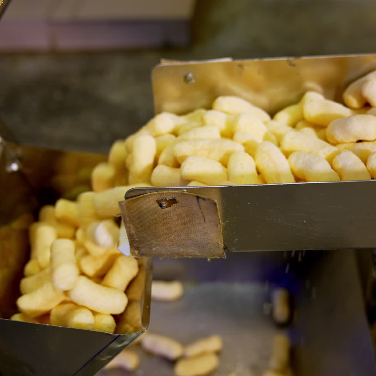Factory producing crispy corn sticks. Sweet healthy puffcorn sticks making