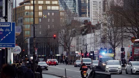 busy street in east london, gherkin in the background
