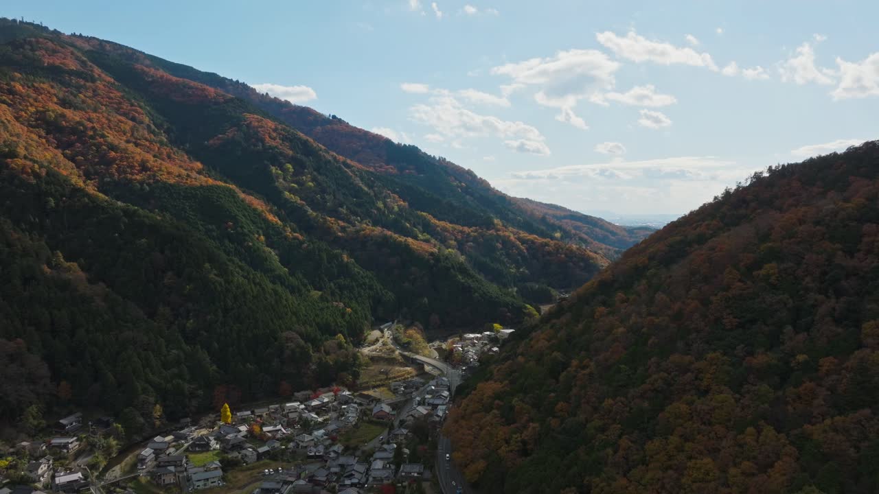 Aerial establishing fly Yase neighborhood in Japan, Autumnal Valley Landscape at Mount Hiei, daylight skyline