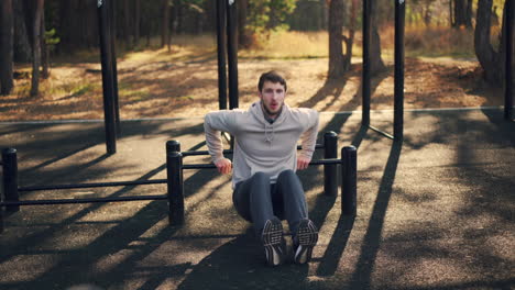 man doing push-ups outdoors at a park