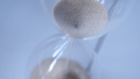 Hourglass-sand-falling-in-slow-motion-from-above