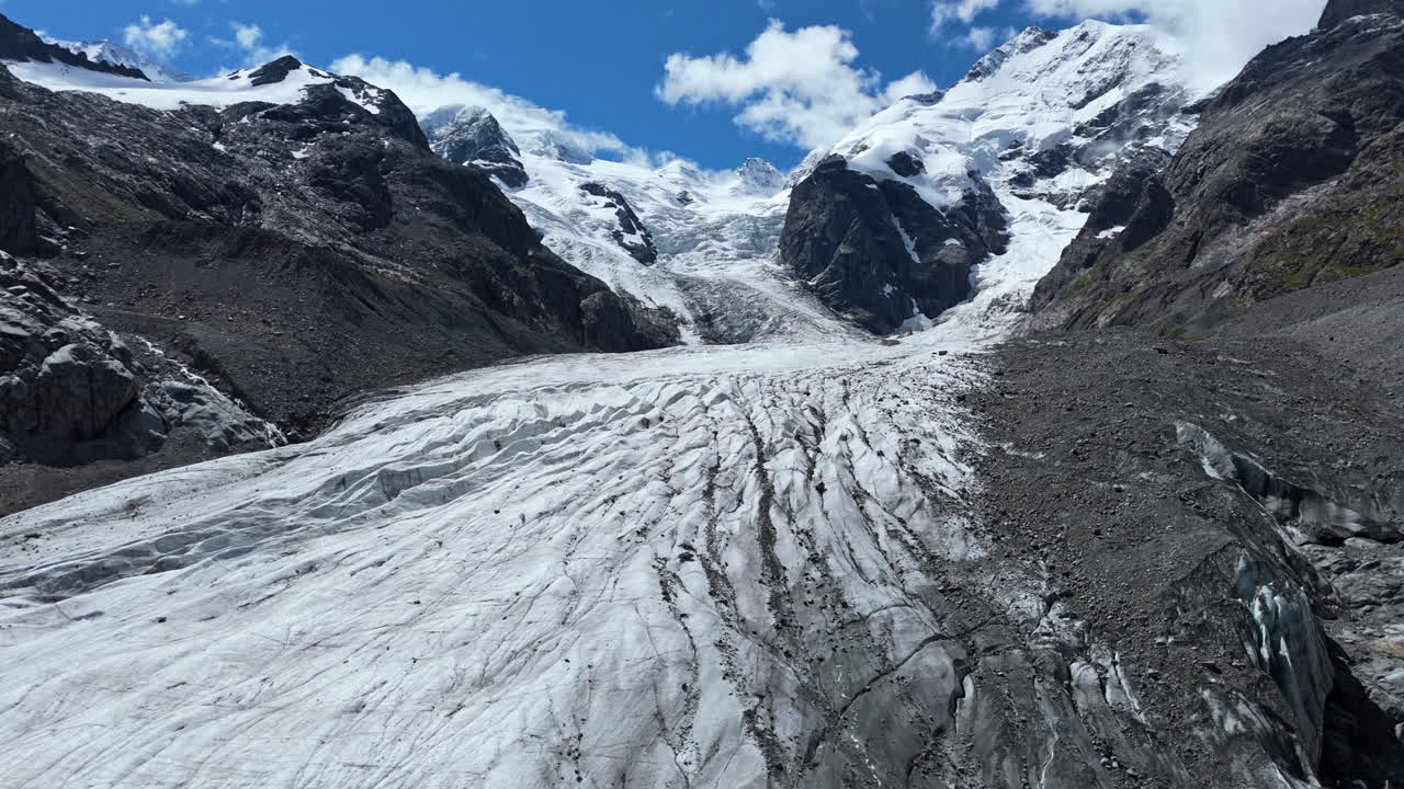 Majestic Morteratsch Glacier under bright blue skies and rugged mountain peaks