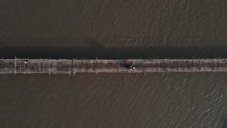 Aerial footage shows a wooden bridge spanning the Progo River, passable by motorbikes. As a link between the villages of Bantul and Kulonprogo.