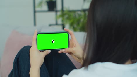 close up horizontal hands holding smartphone with green screen. green screen mobile phone with chroma key.