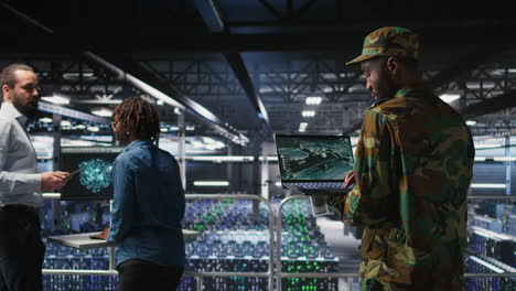 military server hub technician reviewing tactical dashboard on laptop