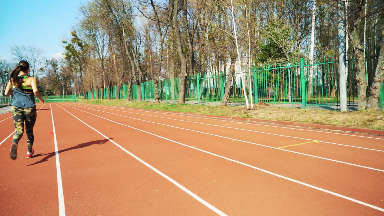 Athletic woman running on track. Healthy fitness lifestyle.