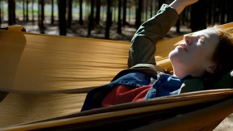 woman relaxing on a hammock in the forest 4k