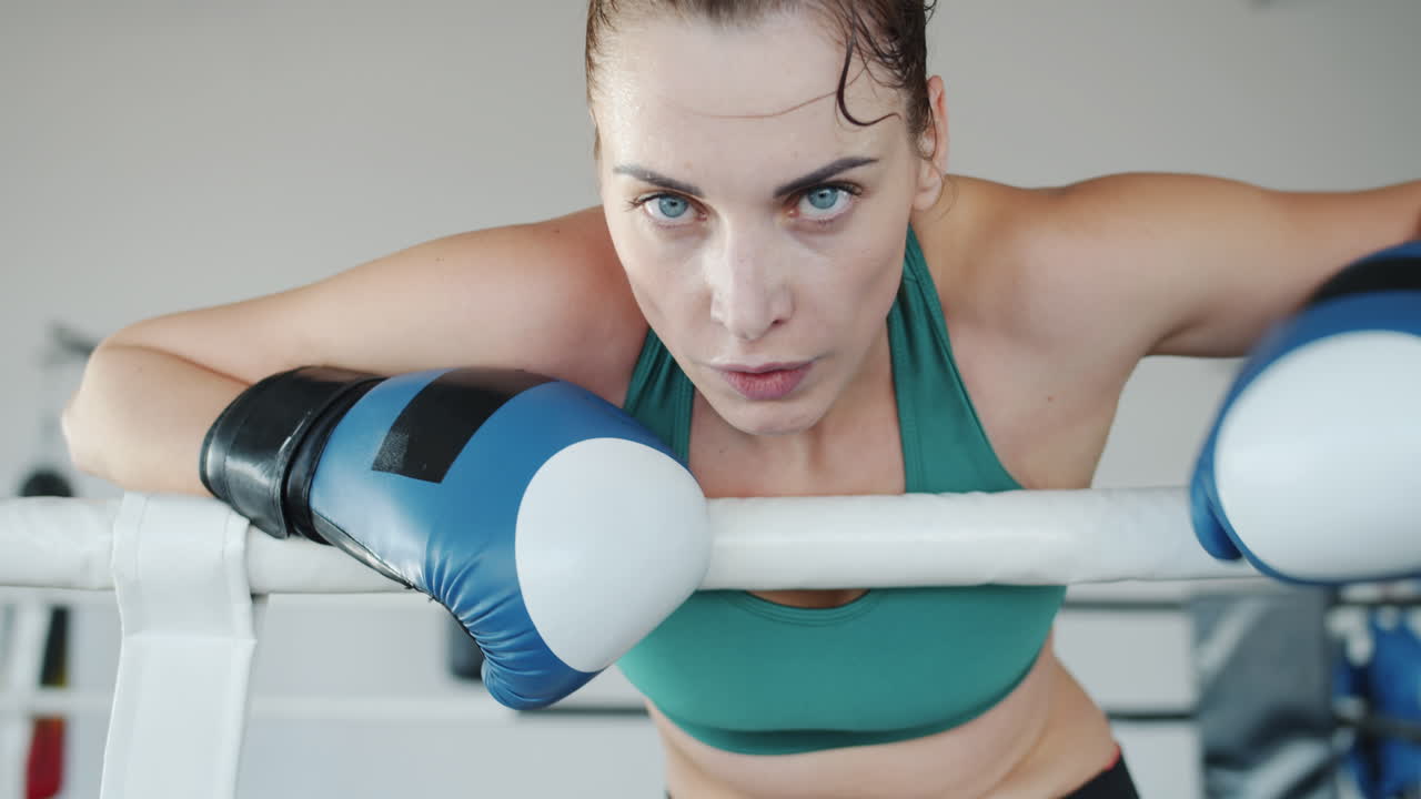 Woman Boxer Resting in Boxing Ring