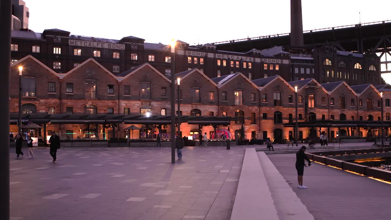 Evening view of Metcalfe Bond buildings along a Sydney waterfront promenade
