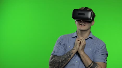 man using vr app helmet to play simulation game, drawing. guy watching virtual reality 3d video