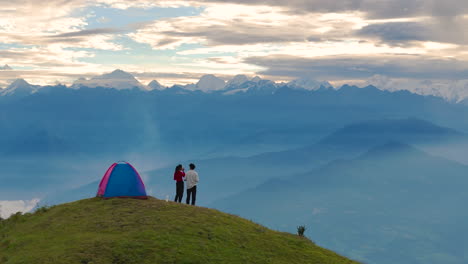 a bird's eye view captures romantic couple embracing life while camping in hills of sailung, dolakha, nepal