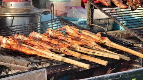 skewered chicken being cooked on an open grill