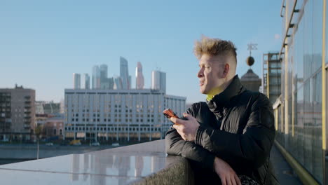 man using a smartphone in a city