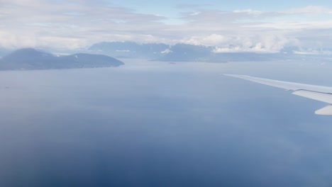 Plane-turning-above-oceans-and-islands