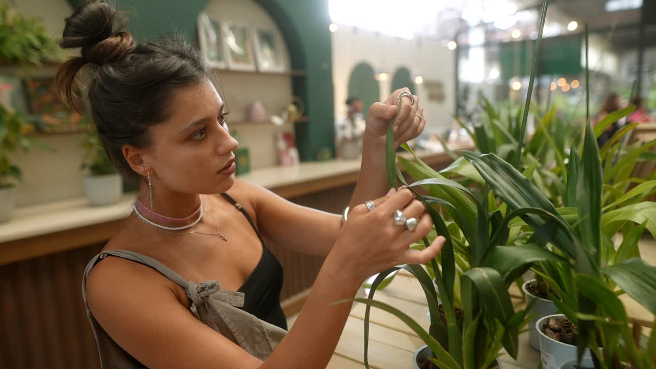 Woman tending to plants indoors