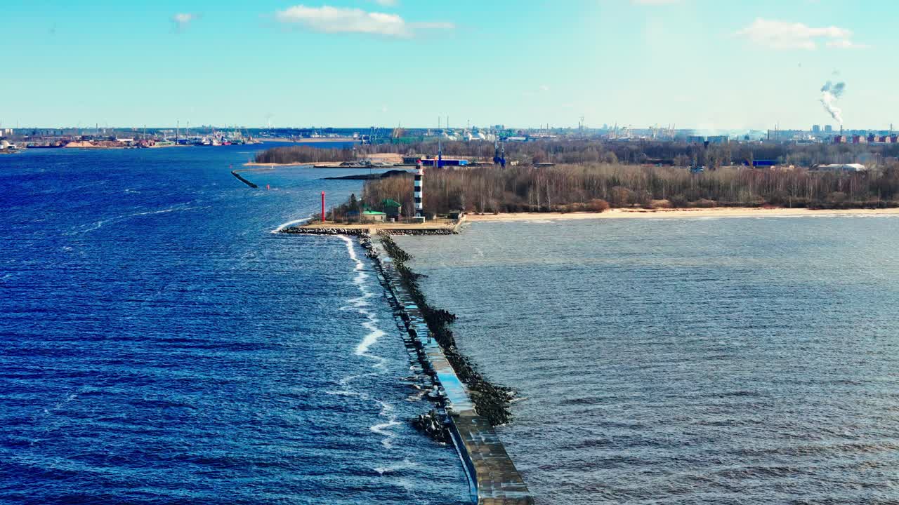 Bolderāja's Coastal Embrace Sunny Summer Aerial View of the Bolderāja pier, Where the Deep Blue Waters of the Riga Gulf Meet the Lighter Hues of the Daugava River Distinctive Red and White Lighthouses