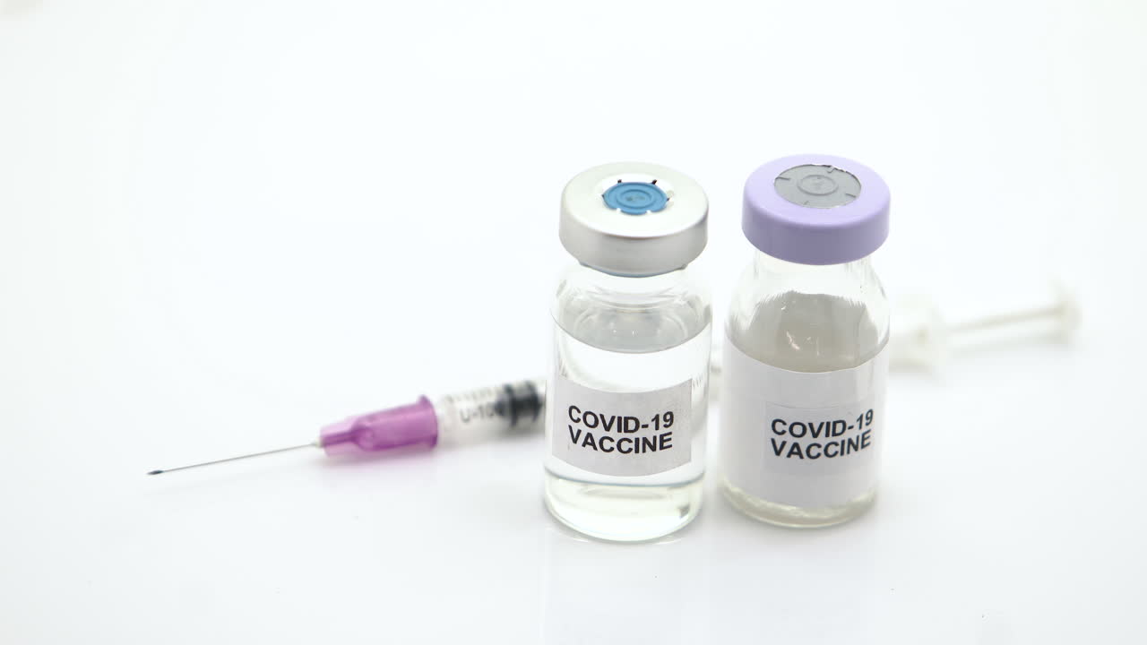 The vaccines and syringes are used to prevent vaccination from COVID-19 on a white background.Shift focus move ment