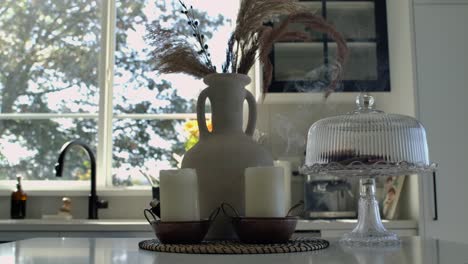 woman blows out candles on kitchen table - interior design static shot