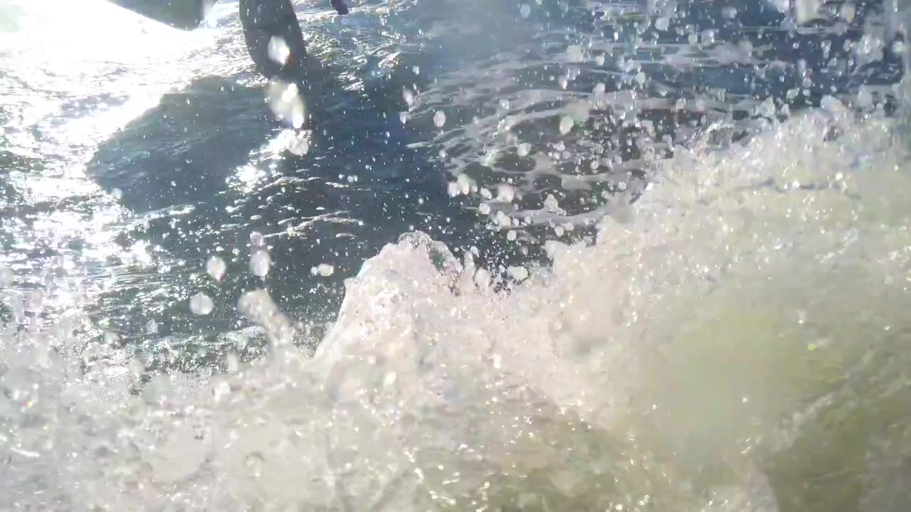 Sea wave in the rays of the sun. Shooting in the summer.
