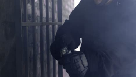 mid section of soldier throwing smoke grenades in building during military exercise 4k