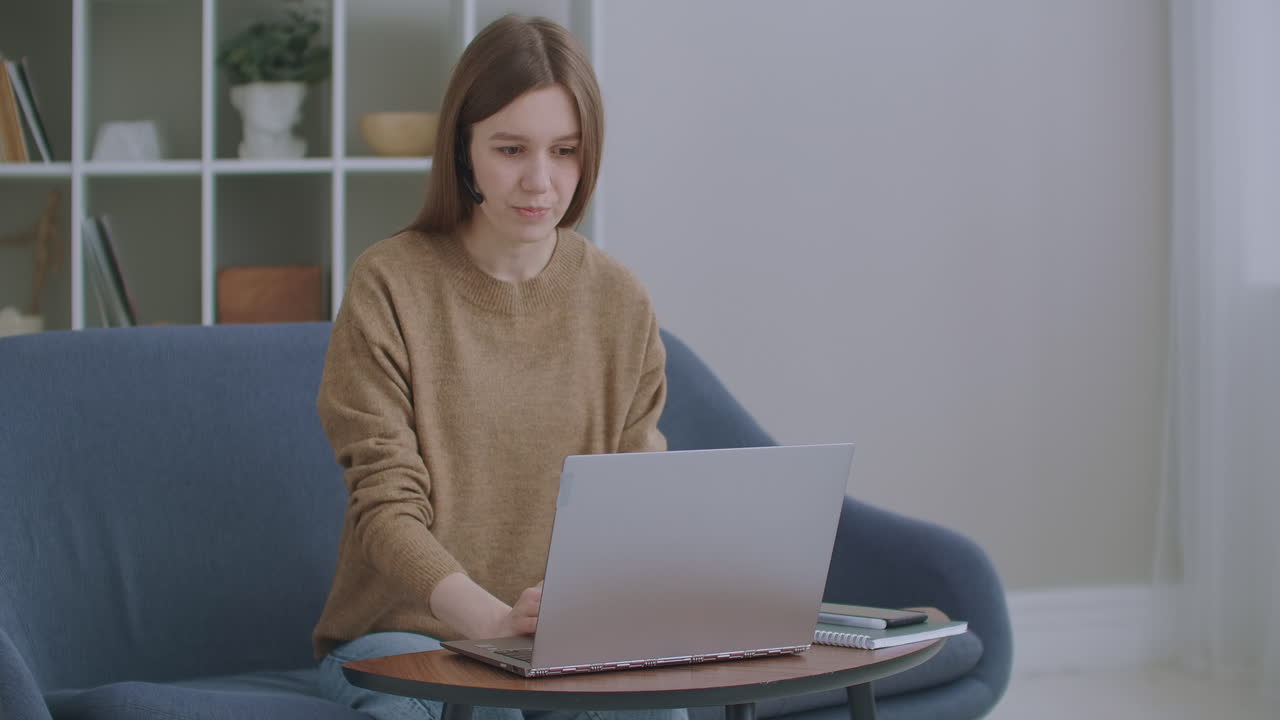 call center agent wear headset video calling laptop. business woman wears headset talks web camera making distance online video conference call. Internet teacher doing distant chat working from home.