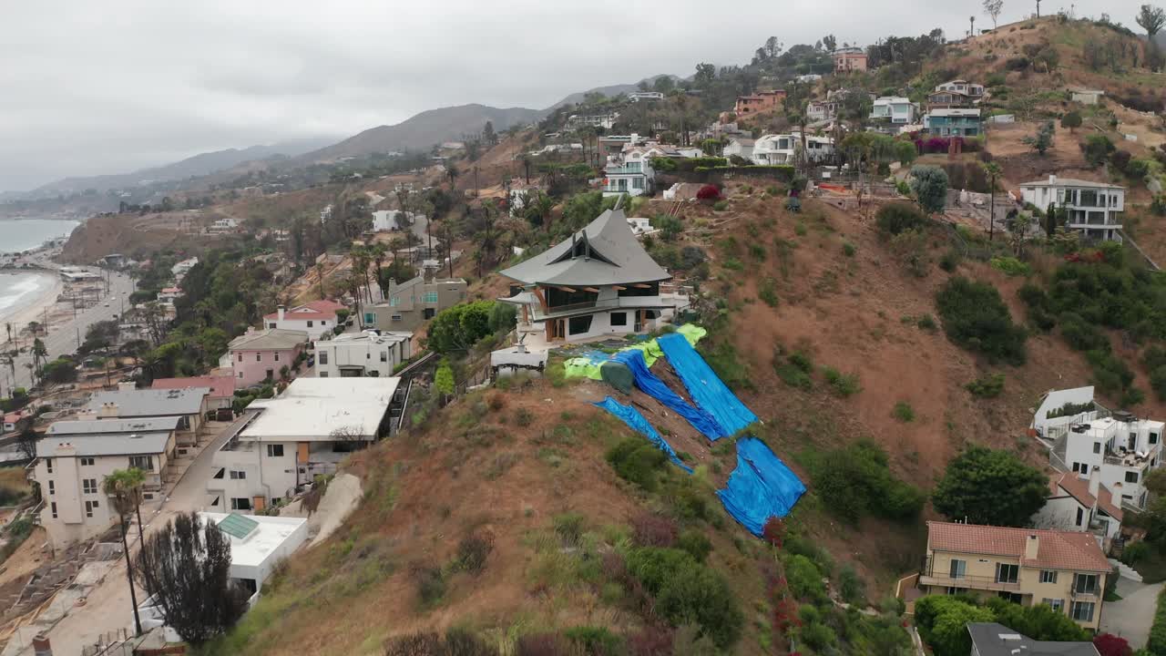 Low rising aerial shot of cleared residential lots at the Las Flores neighborhood after the Palisades Fire in Malibu, California. 4K