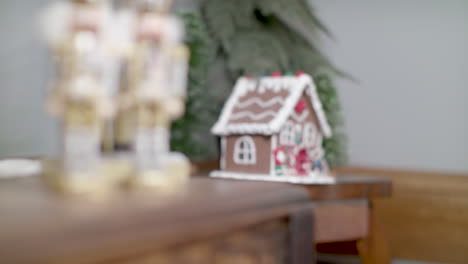 a pair nutcrackers and a gingerbread house sit on top of tables as decoration for the christmas holiday season