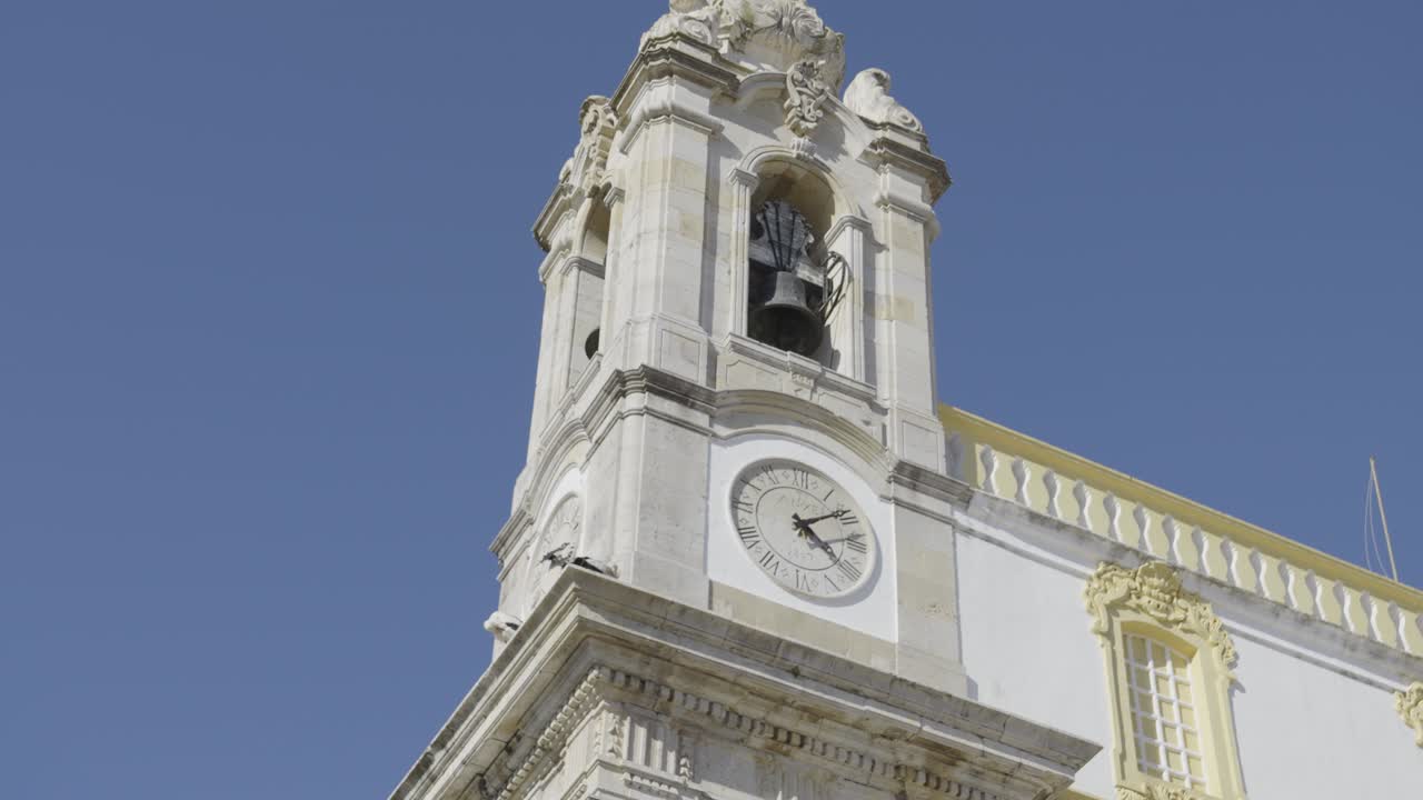 Scenic shot capturing the architecture and clock tower of Faro’s Igreja do Carmo