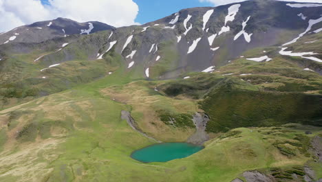 cinematic wide descending drone shot of oreit lake in tusheti georgia, in the caucasus mountains