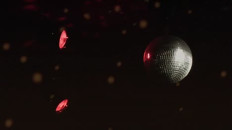 Animation-of-spinning-glowing-disco-mirror-ball-and-snow-falling-on-black-background