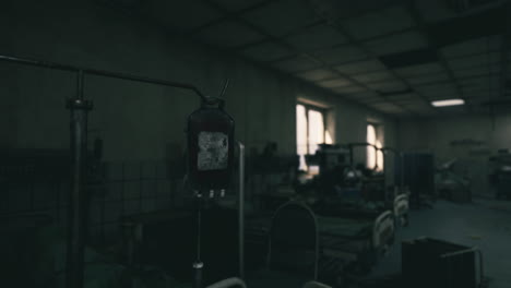 Dark hospital room with an intravenous drip hanging in the foreground
