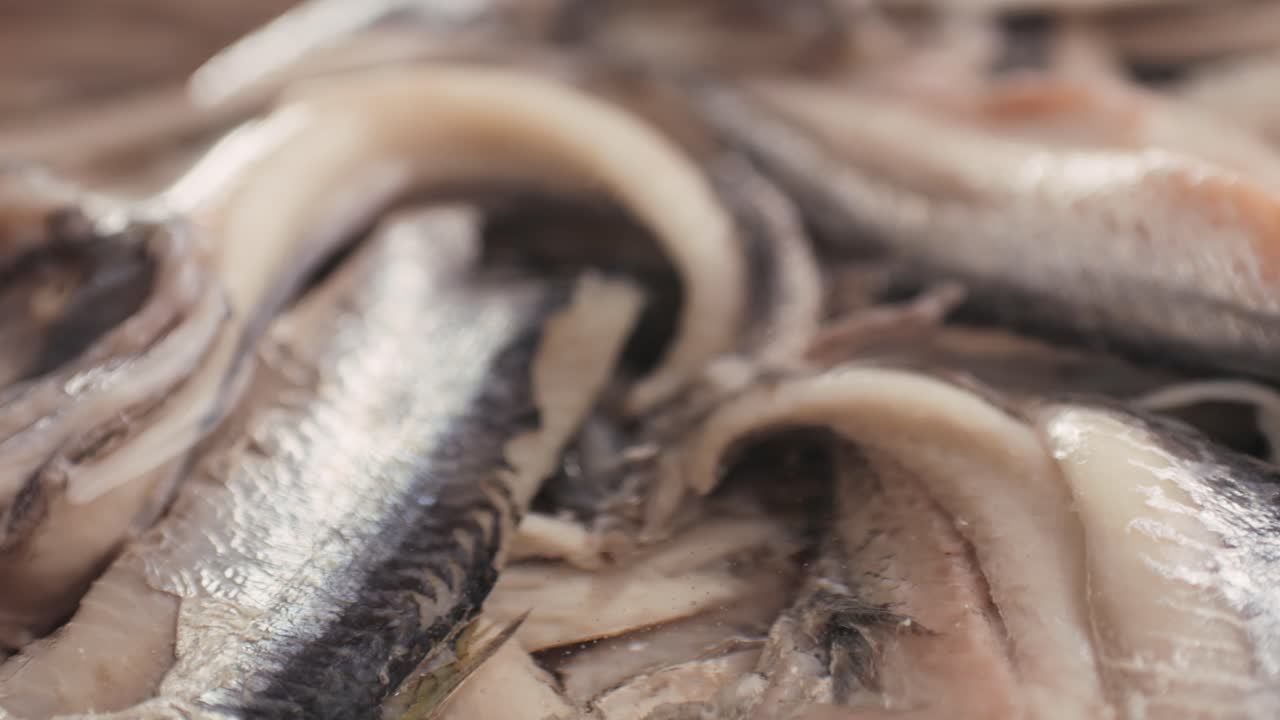 Fresh Sea sardines and Anchovy Fish and Mullus On Display On Ice On Market Store Shop. Seafood Fish Background, close up stand of small salty white fish.