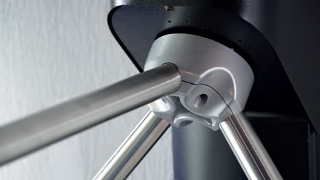 woman passing the turnstile entering a gym wearing grey yoga pants on close up.
