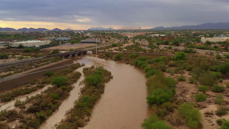 drone flies over flooded riverbed in arizona after heavy rain