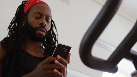 male boxer using mobile phone while exercising 4k