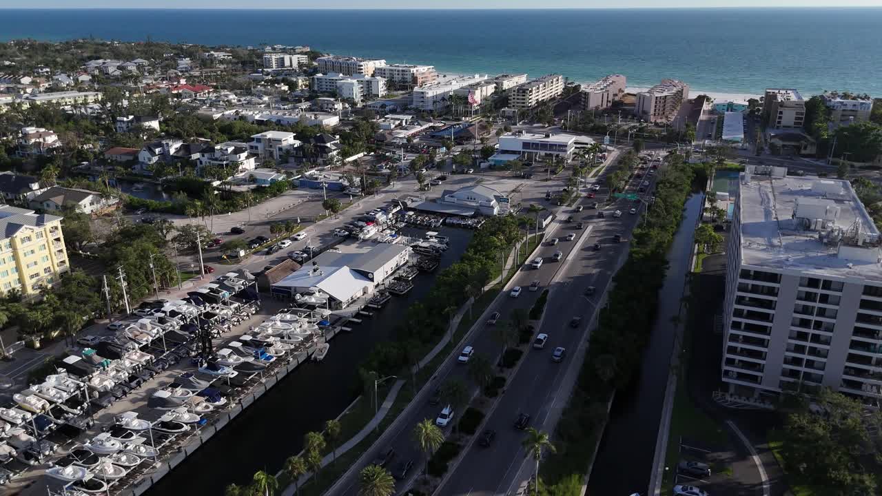 sunny beach day aerial arrival at the beaches of Siesta Key Island after Stickney Point Bascule Bridge in Florida