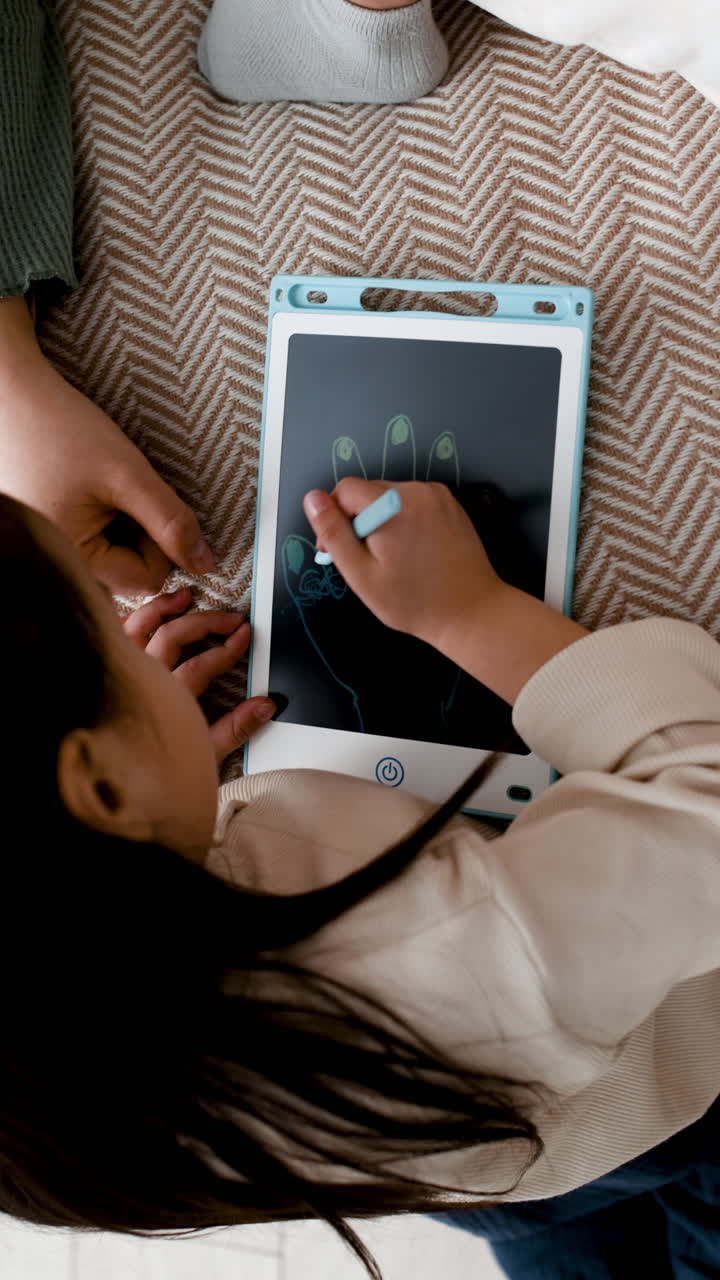 Child drawing on a digital drawing tablet