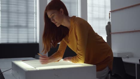 Caucasian woman working in fashion office
